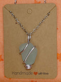 Teal wire wrapped sea glass in silver setting