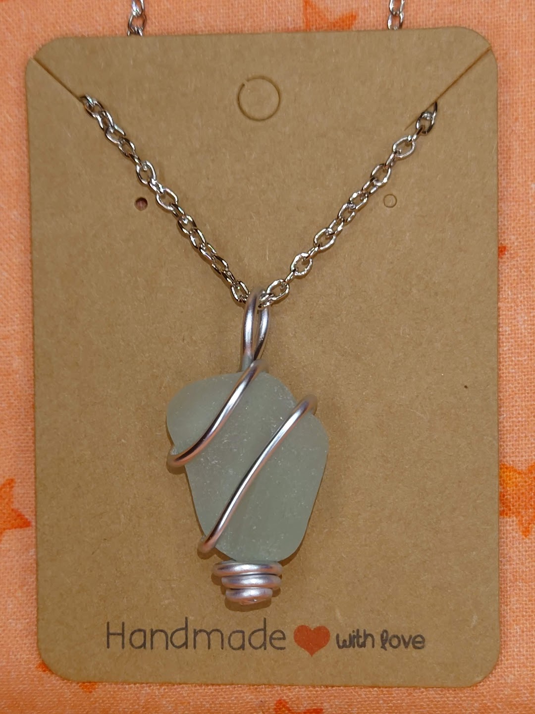Teal wire wrapped sea glass in silver setting